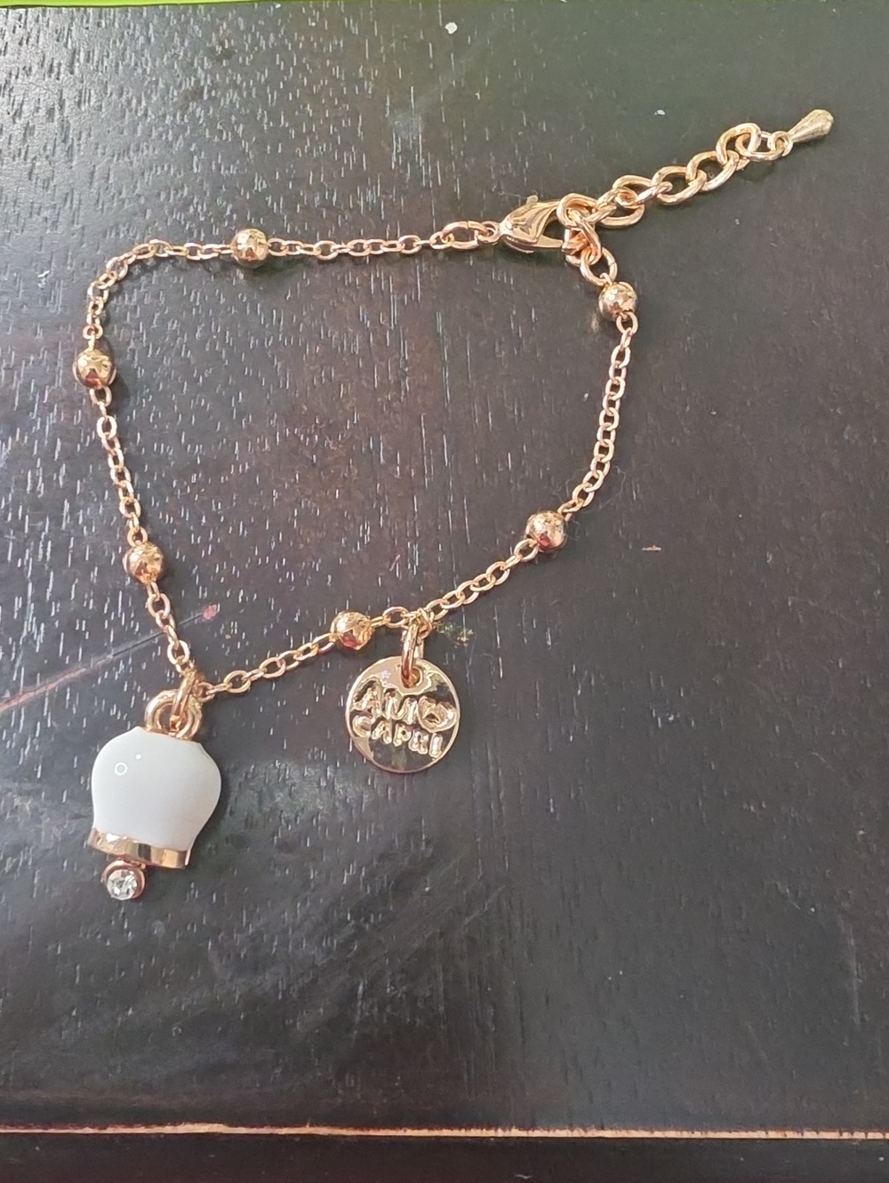 Gold Tone Bracelet with White Charm and Crystal Accent